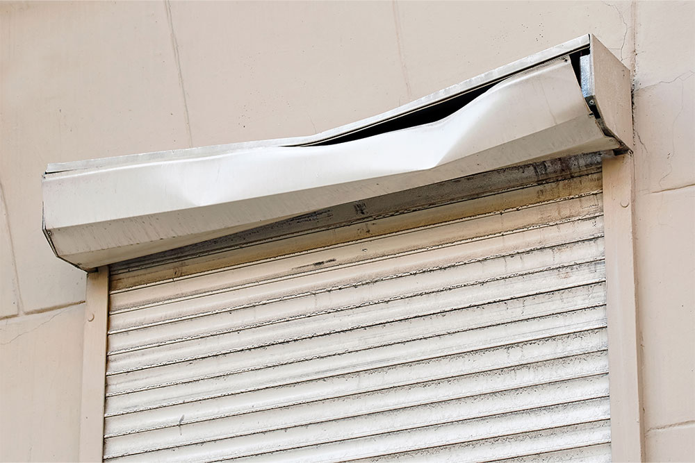 Severely damaged roller shutter frame.