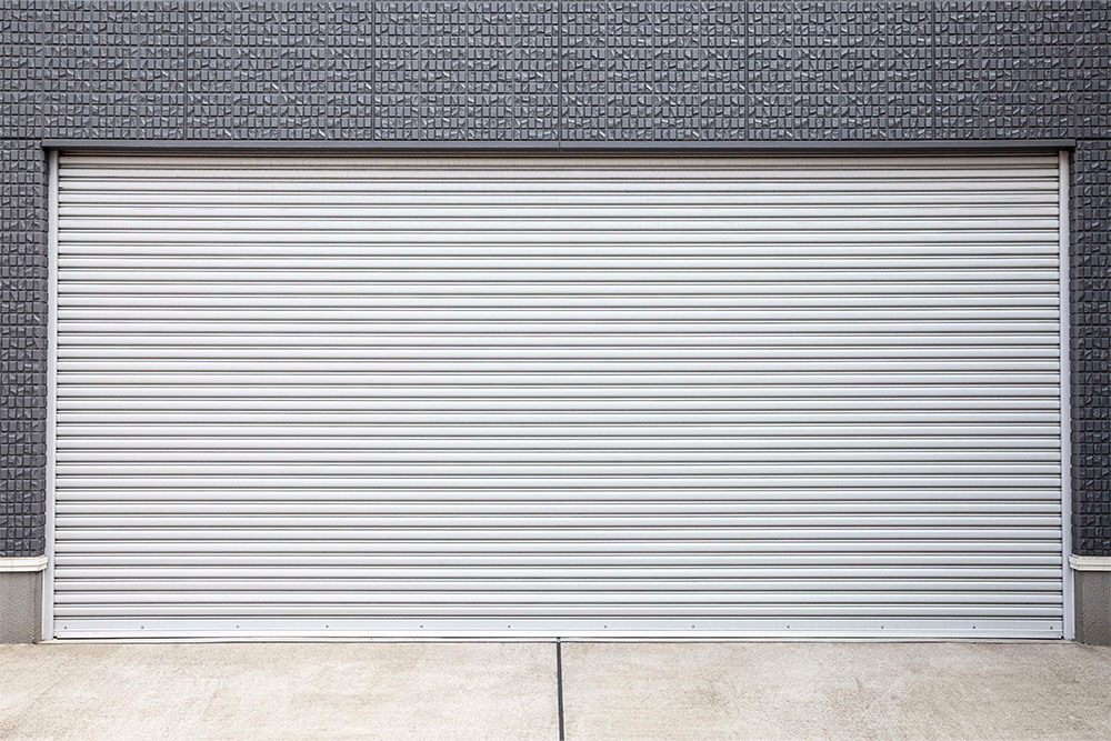 Grey roller door installed on a residential garage.