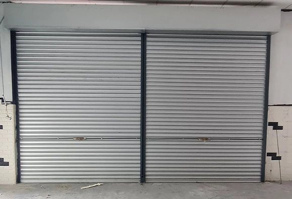 Double storefront in Malaysia with a closed Zincalume roller shutter