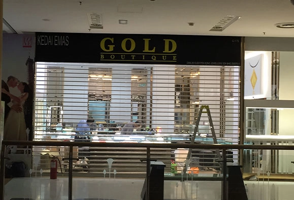 Gold boutique storefront with roller shutter in Malaysia