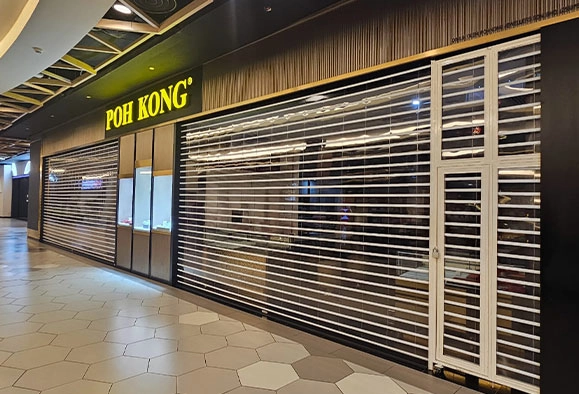 Two roller shutters on a Poh Kong storefront in Malaysia