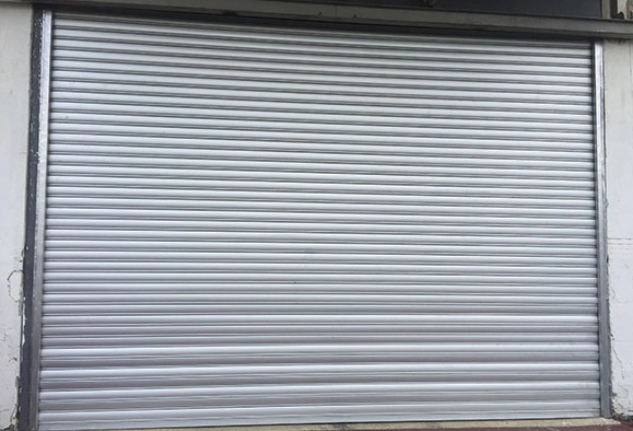 Single storefront in Malaysia with a closed Zincalume roller shutter